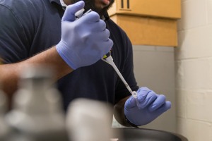person filling a test tube